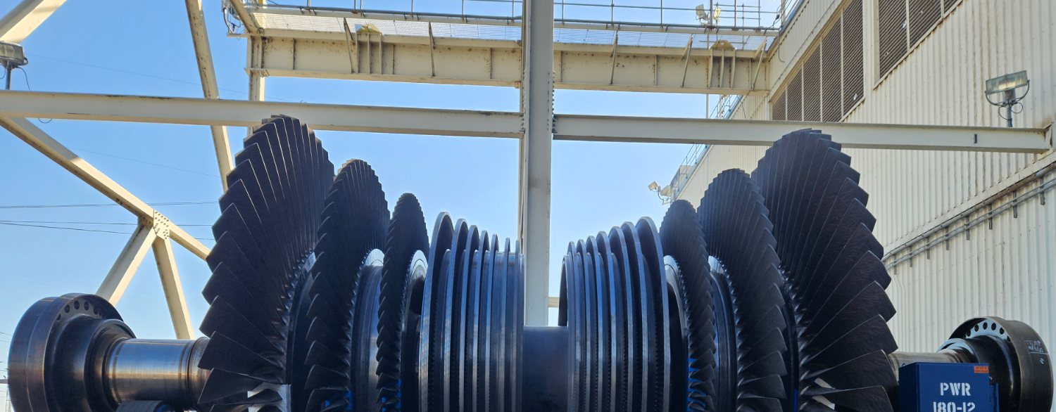 Steam turbine rotor on balance stands under gantry